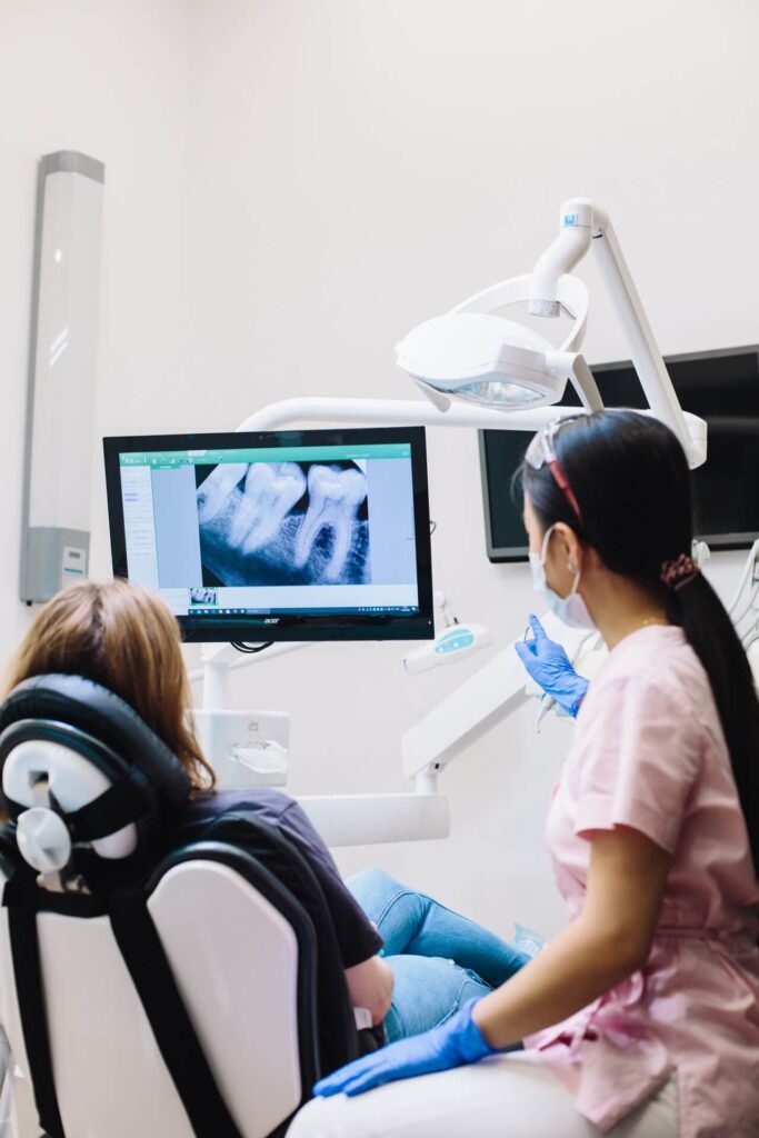 dentist explains x-ray findings to patient