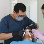 dentists clean patient's teeth