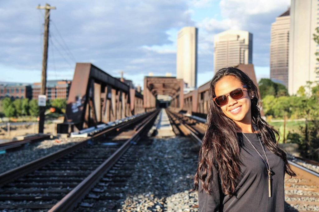 Woman poses for a photo at a railroad track near Columbus