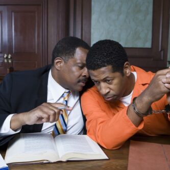 Criminal defense lawyer advises client in court