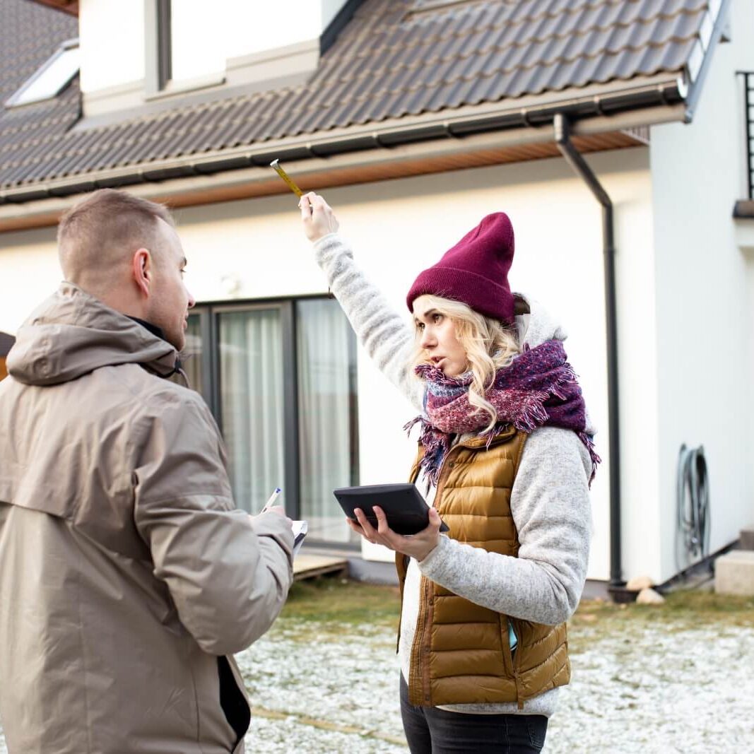 Roofer discusses job with homeowner