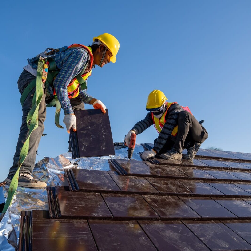 Roofers put down shingles